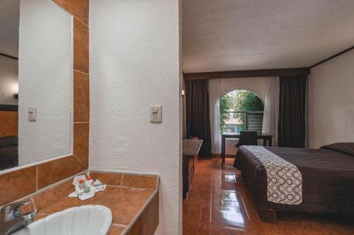 Postel nebo postele na pokoji v ubytování Hotel & Suites Villa del Sol