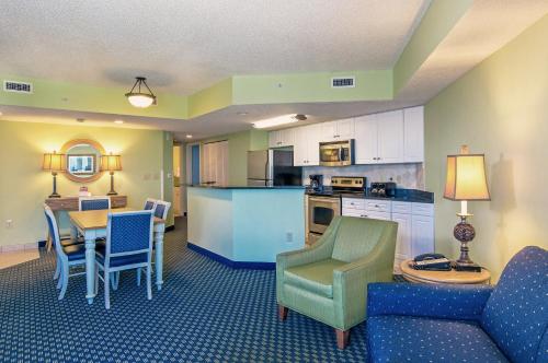 a kitchen and living room with a table and chairs at Caribbean Resort Myrtle Beach in Myrtle Beach