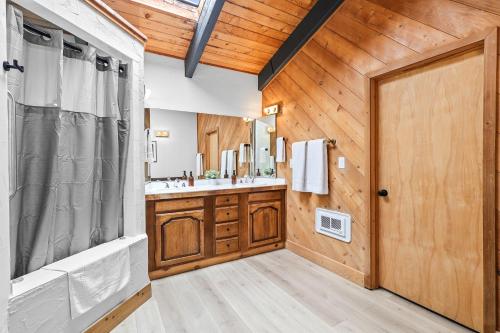 a bathroom with wooden walls and a wooden door at Basecamp Lodge in Mount Shasta