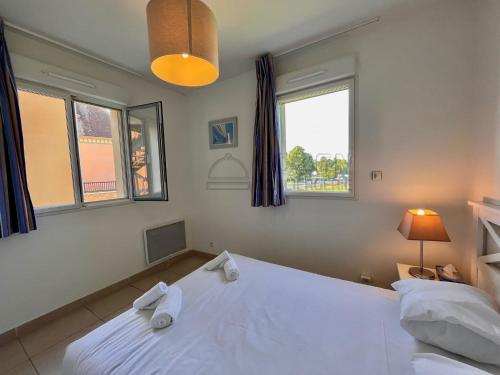 a bedroom with a white bed and two windows at B08 1er etage La Ferme de Deauville 1 ch SOZEN C in Saint-Arnoult