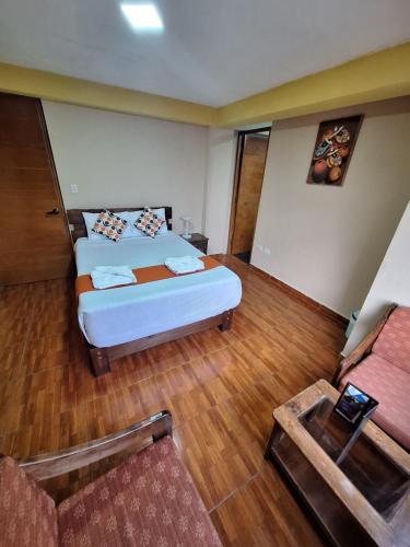 a hotel room with a bed and a couch at Chaska valle Inn in Urubamba