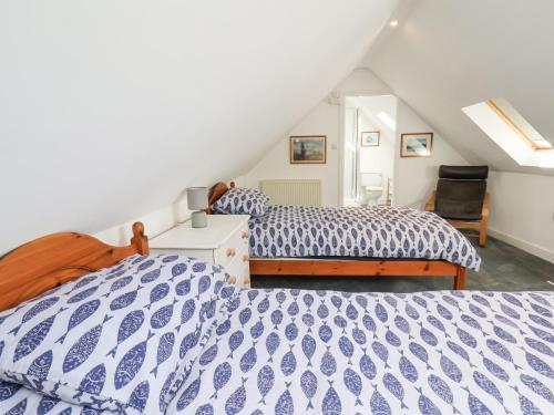 two beds in a bedroom with a attic at 1A Police House in Whitby