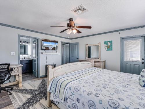 a bedroom with a bed and a ceiling fan at Shore Better Than Work in Rockport