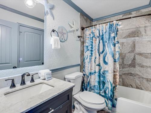 a bathroom with a sink and a toilet and a shower curtain at Shore Better Than Work in Rockport