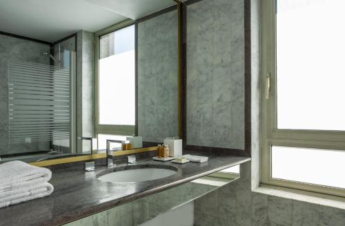 a bathroom with a sink and a mirror at Royal Garden Champs-Élysées in Paris