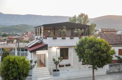 a white house with plants on the top of it at Vila Franko in Berat