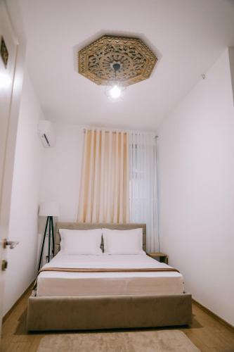 a bedroom with a bed and a ceiling at Vila Franko in Berat