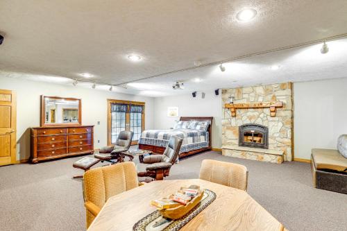 a living room with a couch and a fireplace at Just a Cast Away Cassville Cabin with Covered Deck in Cassville