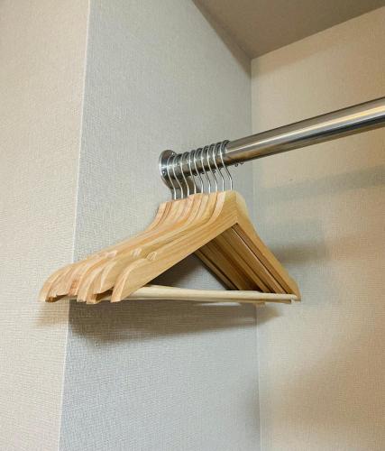 a wooden shelf on a wall with a shower curtain at Kyoto Sanjo Ohashi in Kyoto