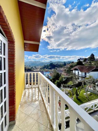 a balcony with a view of the city at Pousada Geada de Campos in Campos do Jordão