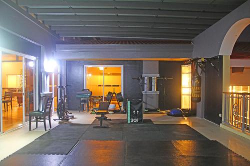 a room with a gym with chairs and a table at Hotel Palacio Puerto Princesa in Puerto Princesa City