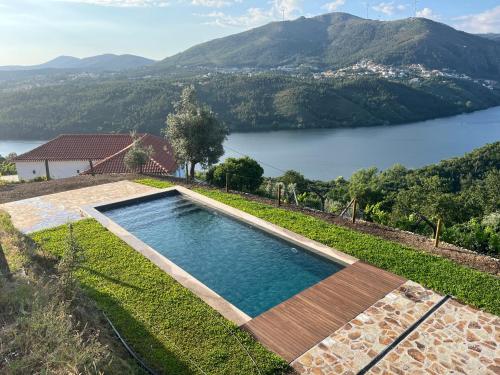 a swimming pool with a view of a lake at Douro House 222 in Castelo de Paiva