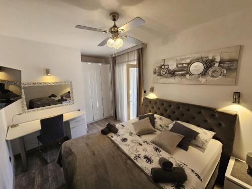 a bedroom with a bed and a desk and a ceiling fan at Apartments with WiFi Vis - 19923 in Vis