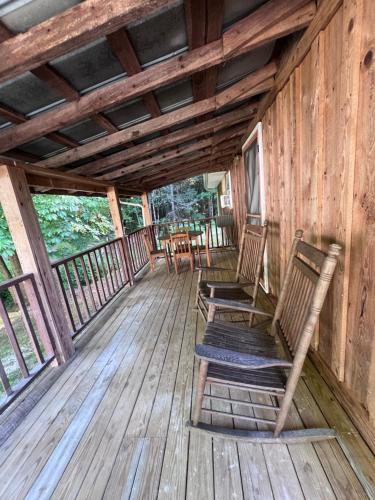 two chairs sitting on the deck of a cabin at The Eagles Nest in London