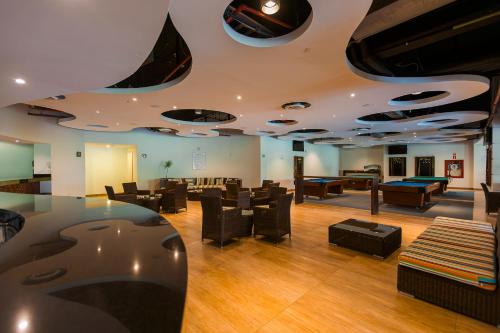 a lobby with couches and tables and a pool table at Azul Ixtapa Grand All Inclusive Suites - Spa & Convention Center in Ixtapa