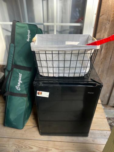a black basket sitting next to two green bags at The Eagles Nest in London
