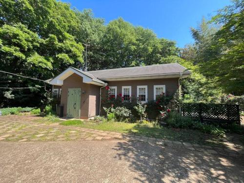 a small house with a fence in front of it at Rose Garden Esta in Kashiwa