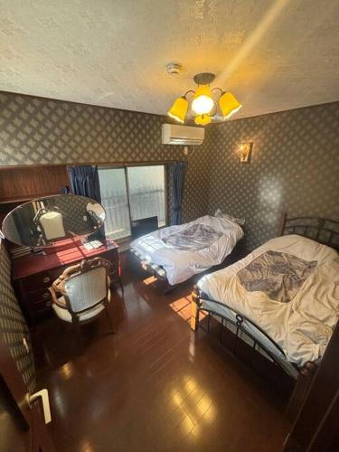 an overhead view of a bedroom with two beds and a desk at Rose Garden Esta in Kashiwa