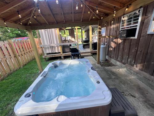 a jacuzzi tub in a backyard with a patio at The Eagles Nest in London