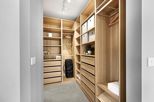 a walk in closet with wooden cabinetry at Hillgrove - Sophisticated & Refined Entertainer in Bathurst