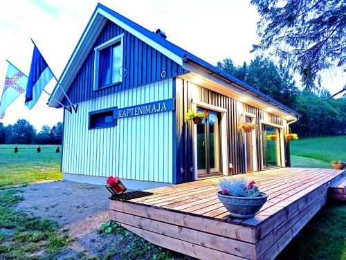 a small house on a wooden deck in a field at Seto Kapten in Meremäe