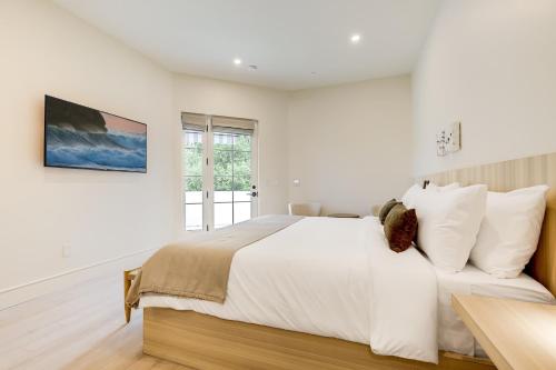 a white bedroom with a large bed and a window at Casa De La Vina - Boutique Suites in Downtown Santa Barbara in Santa Barbara