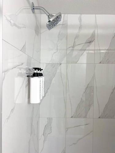 a shower with a shower head in a bathroom at Guest Suite in SouthWest Edmonton in Edmonton