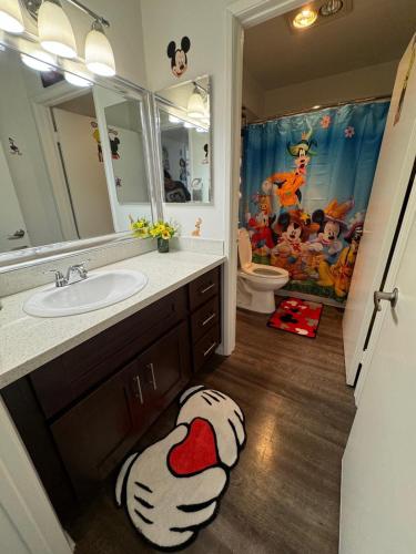 a bathroom with a mickey mouse rug on the floor at Mario, Disney & not themed Loft Universal Studios 10min loft apartment in Los Angeles