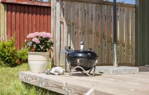 a grill sitting on a table next to a vase of flowers at Holiday Home Flejmose Sydals Vi in Kegnæshøj