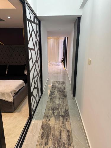 a hallway with a mirror and a bed and a rug at S 22 Marina City in Port Ghalib