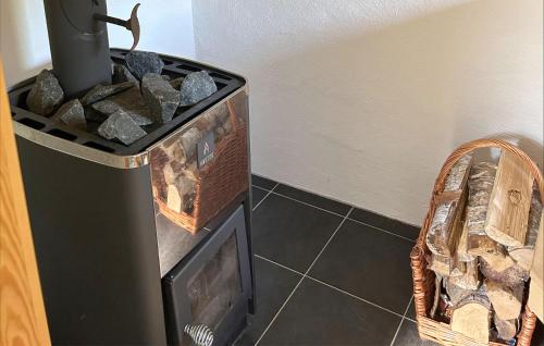 a corner of a room with a tv and a basket at Gorgeous Home In Brösarp With Wifi in Brösarp