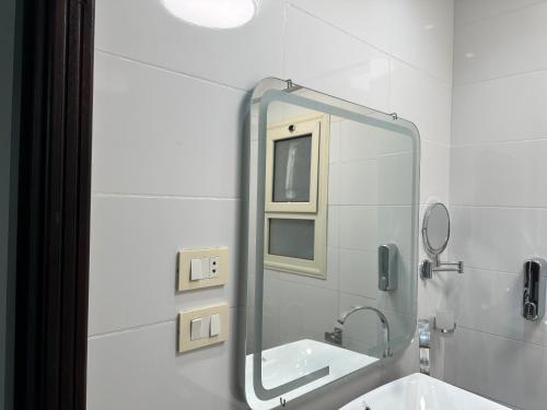 a bathroom with a mirror and a sink at S 22 Marina City in Port Ghalib