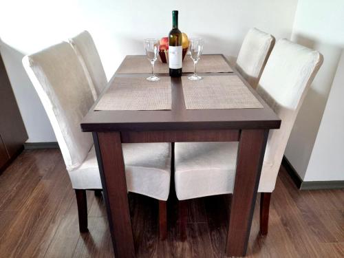 a wooden table with a bottle of wine and wine glasses at Casablanca in Sutomore