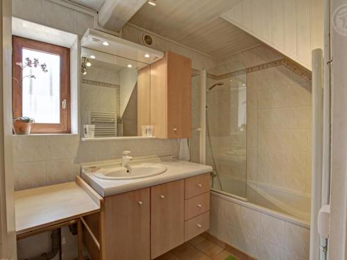 a bathroom with a sink and a shower at Gîte avec piscine, cheminée, jardin, et animaux acceptés - FR-1-496-32 in Belmont-de-la-Loire