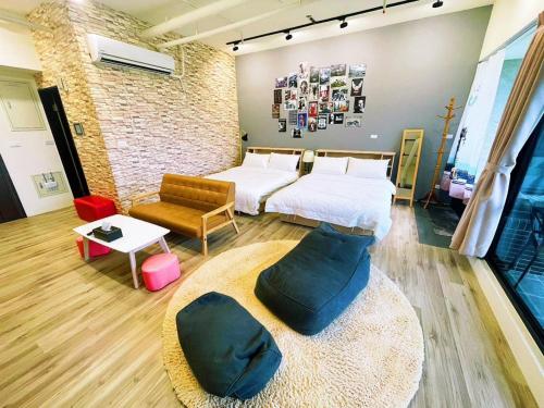 a room with two beds and a couch in it at 光嶼海溫泉海景無邊際泳池豪華套房 in Hsin-hsing