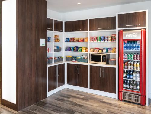 a kitchen with a red refrigerator in a pantry at DoubleTree by Hilton Miami North I-95 in Miami