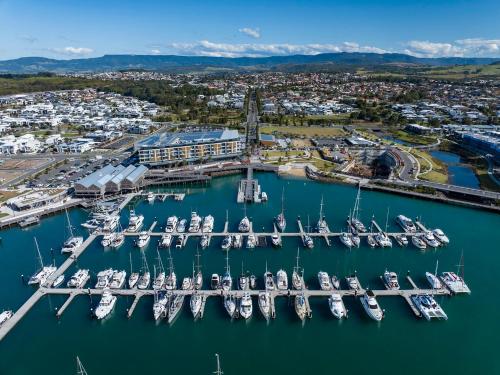 an aerial view of a marina with boats in the water at Waiheke Marina Getaway in Shellharbour