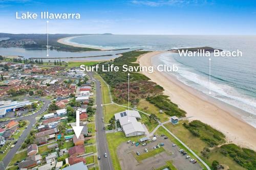 an overhead view of a beach with a surf life saving club at Family Getaway Opposite Warilla Beach in Lake Illawarra