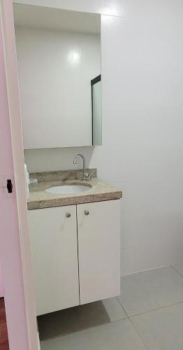 a bathroom with a sink and a mirror at Blend Coliving One - 1 in Ribeirão Preto