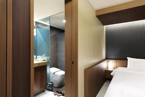 a bathroom with a bed and a toilet in a room at Hotel Sol -The Ryokan and Sauna in Jeonju