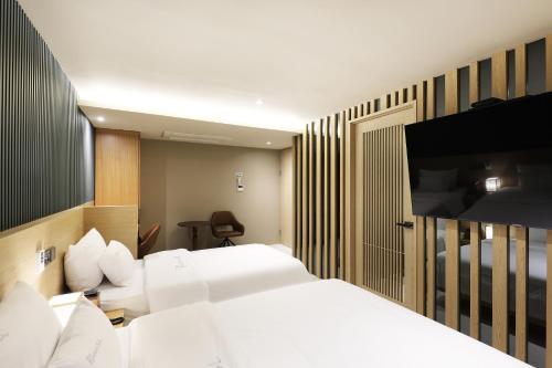 a hotel room with a bed and a television at Hotel Sol -The Ryokan and Sauna in Jeonju