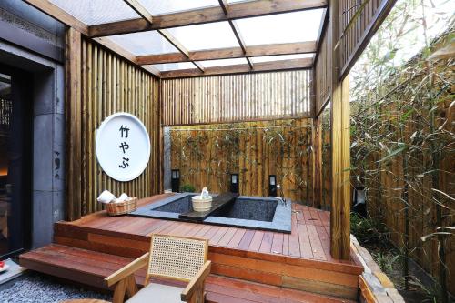 an asian inspired house with a hot tub on a deck at Hotel Sol -The Ryokan and Sauna in Jeonju