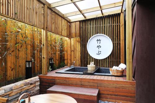 a bathroom with a tub in a wooden building at Hotel Sol -The Ryokan and Sauna in Jeonju