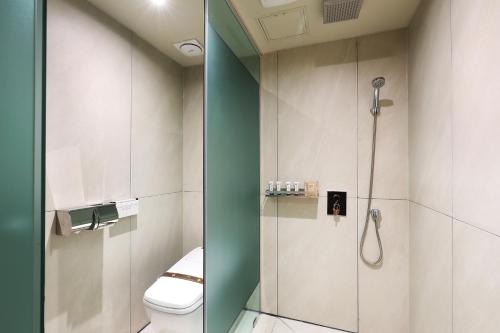 a bathroom with a shower and a toilet at Hotel Sol -The Ryokan and Sauna in Jeonju