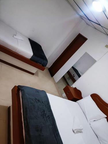 a bedroom with two bunk beds and a bed with a chair at Hotel San Diego DOSQUEBRADAS in Dosquebradas