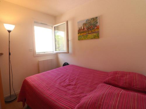 - une chambre avec un lit doté d'une couverture rose et d'une fenêtre dans l'établissement Confortable T3 avec PK privé, climatisation et accès direct à la plage - FR-1-472-201, à Sète