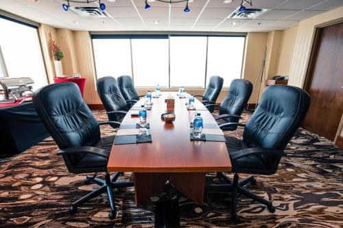 a conference room with a long table and leather chairs at Deerfoot Inn and Casino in Calgary