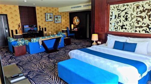 a hotel room with a large bed and a television at Swiss-Belhotel Silae Palu in Palu