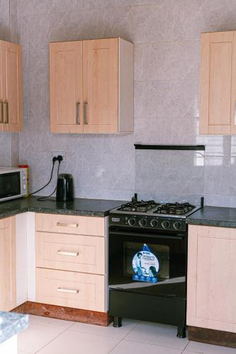a kitchen with a stove top oven in a kitchen at RabiAmar's in Jamisa