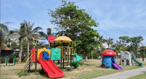 a park with a playground with slides and play equipment at Căn Hộ The Manor Crown in Thôn Trường Giang